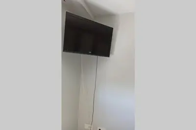 a flat screen tv hanging on a white wall at Apartamento en ribeira sacra. Chantada in Chantada