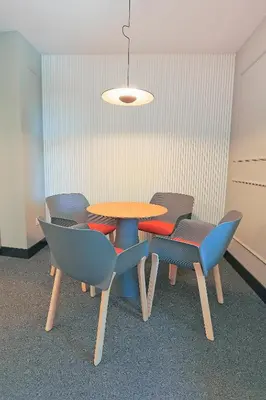 a table and chairs in a room with a light at Azotea Suites in Ponferrada