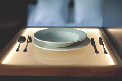 a plate and utensils on a tray with a plate and a bowl at Azotea Suites in Ponferrada