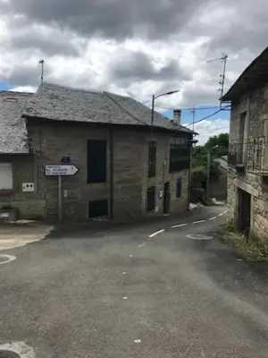 an old building with a street sign in front of it at La Casa Verde de Sanabria de 3 habitaciones y 2 baños in Cerdillo