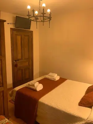 a bedroom with a bed with two towels on it at La Casa Verde de Sanabria de 3 habitaciones y 2 baños in Cerdillo