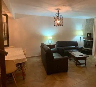a living room with a couch and a table at La Casa Verde de Sanabria de 3 habitaciones y 2 baños in Cerdillo