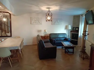 a living room with a couch and a table at La Casa Verde de Sanabria de 3 habitaciones y 2 baños in Cerdillo