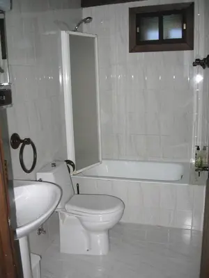 a bathroom with a toilet and a tub and a sink at Casa Turpesa in Peñalba de Santiago