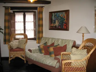 a living room with a couch and two chairs at Casa Turpesa in Peñalba de Santiago