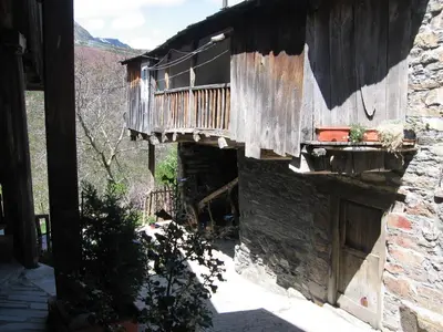 a building with a balcony on the side of it at Casa Turpesa in Peñalba de Santiago