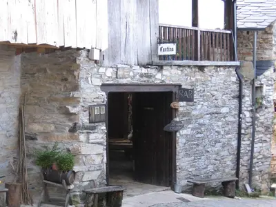 an entrance to a stone building with a wooden door at Casa Turpesa in Peñalba de Santiago
