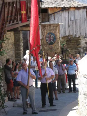 a group of people holding flags in the street at Casa Turpesa in Peñalba de Santiago