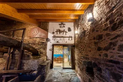 a room with a stone wall and a doorway at Hotel Donas e Cabaleiros in Pousada