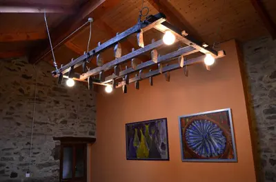 a chandelier in a room with paintings on the wall at Casa Fonte do Barro SPA opcional, de pago in Santiago de Compostela