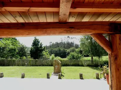 a view of a garden from the outside of a wooden building at Casa Fonte do Barro SPA opcional, de pago in Santiago de Compostela