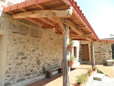 a wooden pergola with a bench on a patio at Casa Fonte do Barro SPA opcional, de pago in Santiago de Compostela