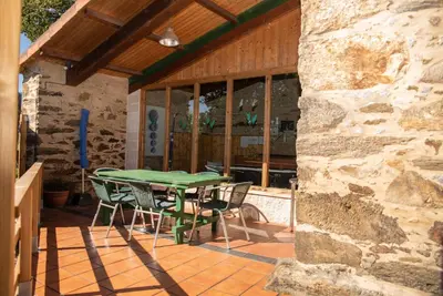 a green table and chairs on a patio at Casa Fonte do Barro SPA opcional, de pago in Santiago de Compostela