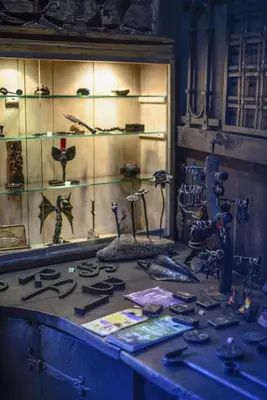 a display case with weapons and other items on a table at La Posada de Oscos II in Santa Eulalia de Oscos