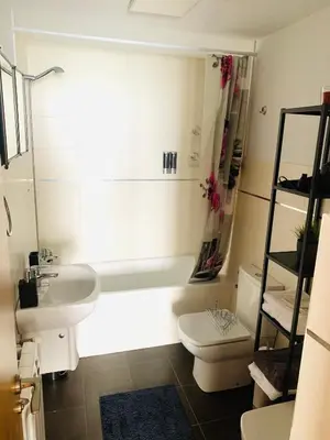 a bathroom with a sink and a toilet and a tub at Apartamentos LAMAROSA - DELUX -PARKING- in Burela de Cabo