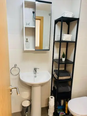 a bathroom with a sink and a mirror at Apartamentos LAMAROSA -PLAYA URBANA in Burela de Cabo