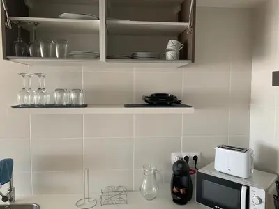 a kitchen with a counter top with a microwave at Apartamentos LAMAROSA -PLAYA URBANA in Burela de Cabo