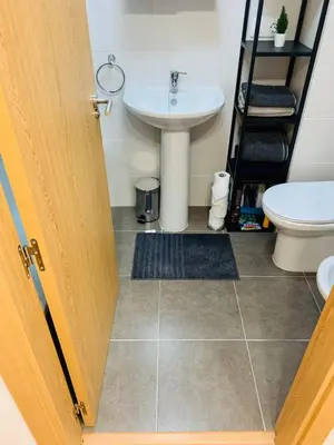 a bathroom with a sink and a toilet at Apartamentos LAMAROSA -PLAYA URBANA in Burela de Cabo