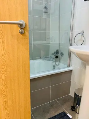 a bathroom with a shower and a tub and a sink at Apartamentos LAMAROSA -PLAYA URBANA in Burela de Cabo