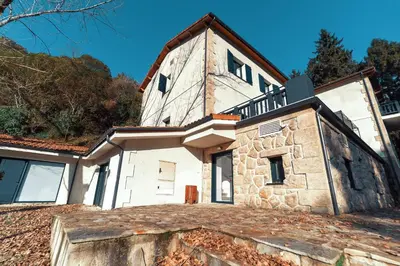 a large white house with a tower at Peares Center Chalet in Carballedo