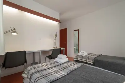 a hotel room with two beds and a mirror at Peares Center Chalet in Carballedo