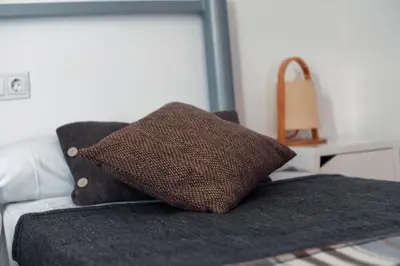 a brown pillow sitting on top of a couch at Peares Center Chalet in Carballedo