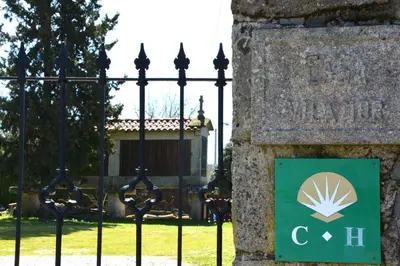 a sign on a fence in front of a building at Duerming Casa Vilamor in Vilamor