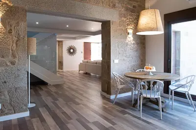 a large lamp above a kitchen counter with stools at ACASADETEO in Padrón