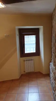 a room with a window and a tile floor at Casa Mariana in Lubián