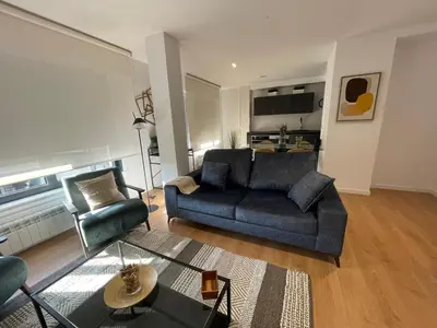 a living room with a couch and a chair at Oktheway Areal Terrace in Oleiros