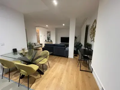 a living room with a table and chairs and a couch at Oktheway Areal Terrace in Oleiros