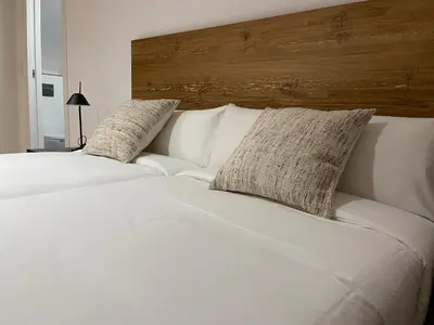 a white bed with two pillows on top of it at Oktheway Areal Terrace in Oleiros