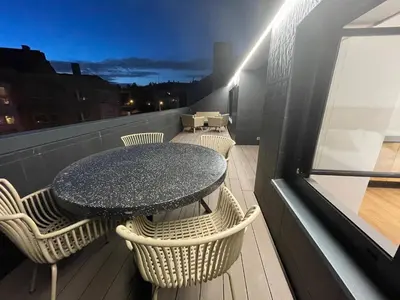 a balcony with a table and chairs on a roof at Oktheway Areal Terrace in Oleiros