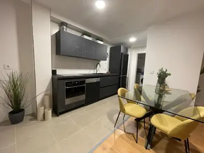 a kitchen with a glass table and chairs in a room at Oktheway Areal Terrace in Oleiros