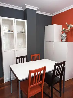 a dining room with a white table and chairs at Viveiro Histórico 3 in Viveiro