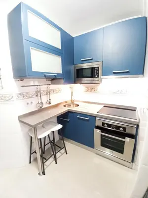 a kitchen with blue cabinets and a sink at Viveiro Histórico 3 in Viveiro
