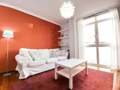a living room with a white couch and a table at Viveiro Histórico 3 in Viveiro