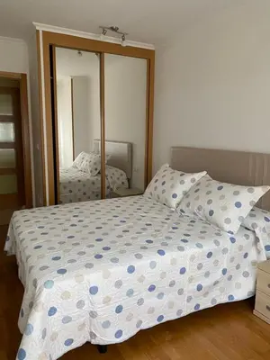 a bedroom with a bed and a large mirror at Piso Vista os castelos in Viveiro