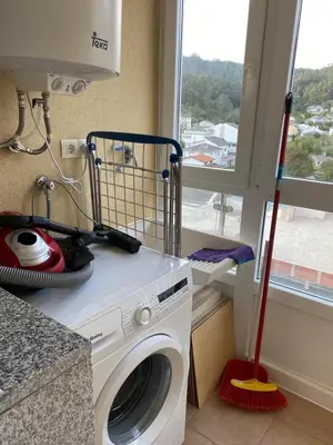 a washing machine in a kitchen with a window at Piso Vista os castelos in Viveiro