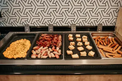 a tray of food on top of an oven at Hotel Lux Melide in Melide