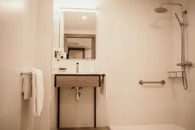a bathroom with a sink and a mirror at Hotel Lux Melide in Melide
