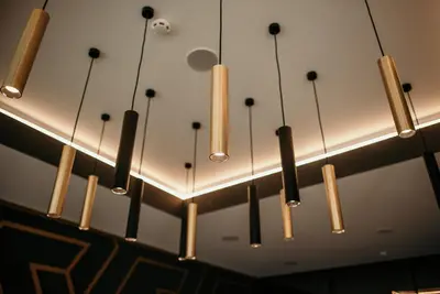 a row of chandeliers hanging from a ceiling at Hotel Lux Melide in Melide