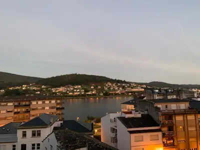 a view of a city with a body of water at Apartamento Porta da Vila in Viveiro