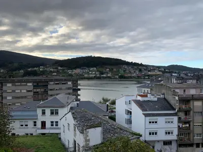 a view of a city with a river and buildings at Apartamento Porta da Vila in Viveiro