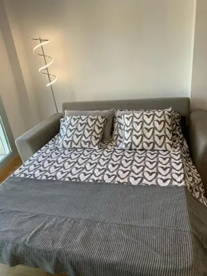 a bed with two pillows on it in a room at Apartamento Porta da Vila in Viveiro