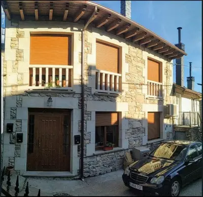 a car parked in front of a house at Casa Cesar in Lubián