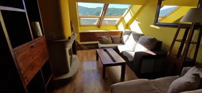 a living room with two couches and a table at Casa Cesar in Lubián