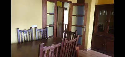 a dining room with a wooden table and chairs at Casa Cesar in Lubián
