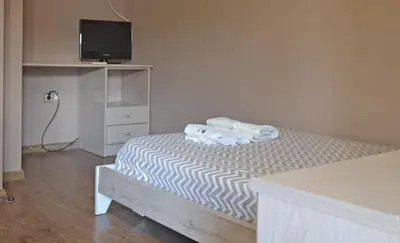 a bedroom with a bed with towels on it at Hotel Rural Val Dos Pigarros in Lubián