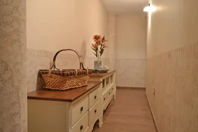 a bathroom with a counter with a basket and flowers at Hotel Rural Val Dos Pigarros in Lubián